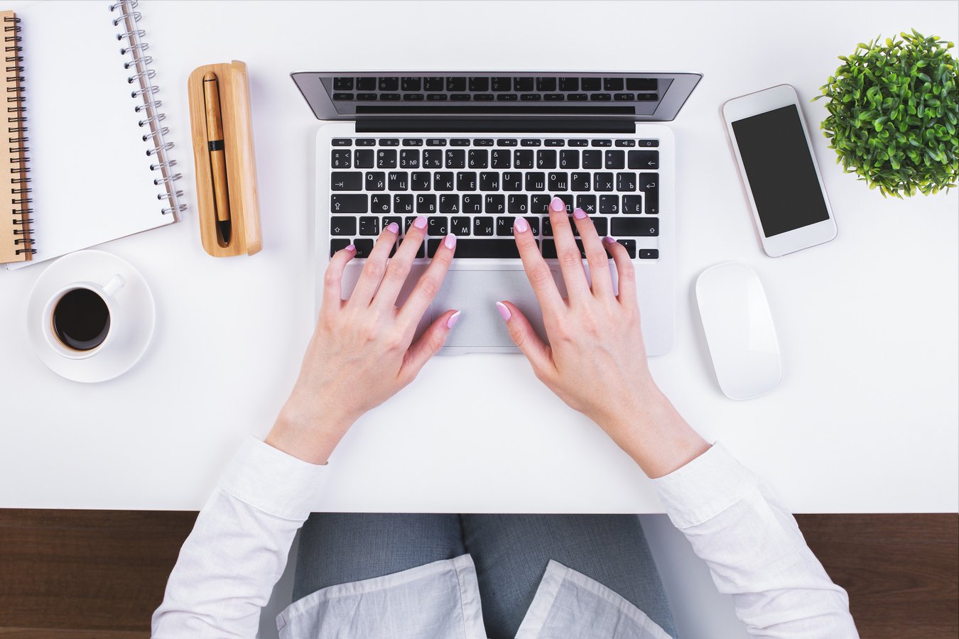 Businesswoman typing on keypad topview